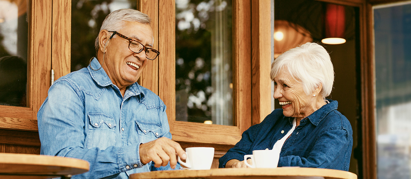 Two elder friends enjoying coffee together