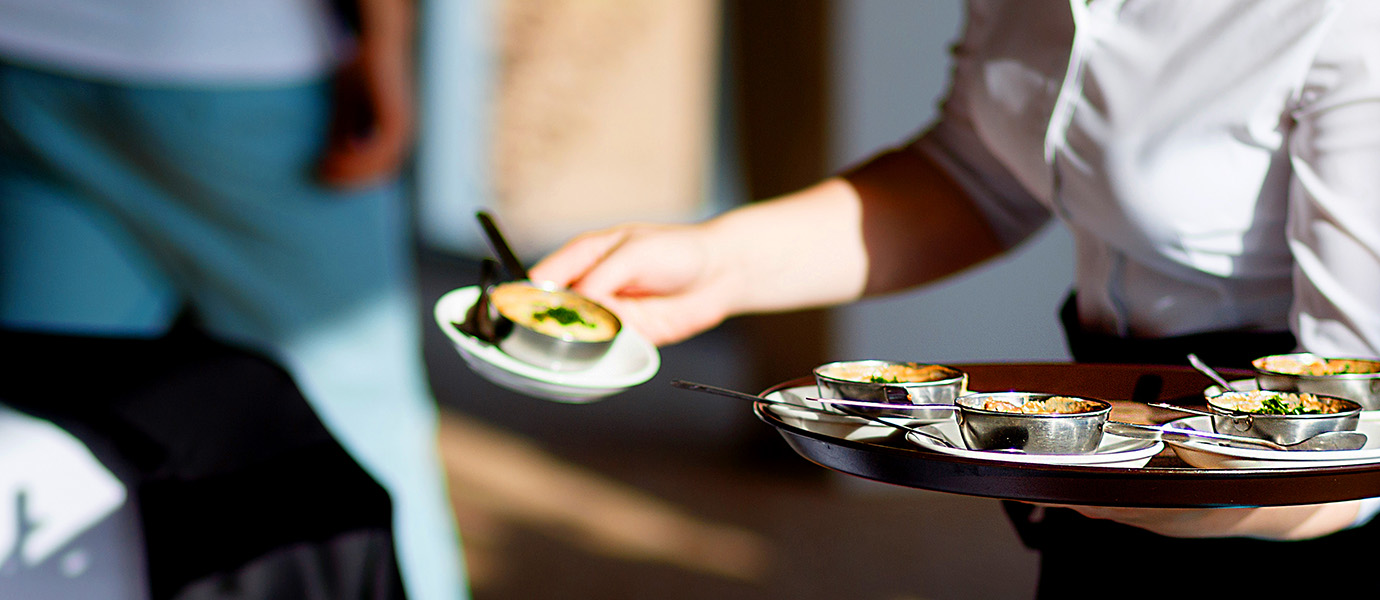 Chef delivering dinner to table