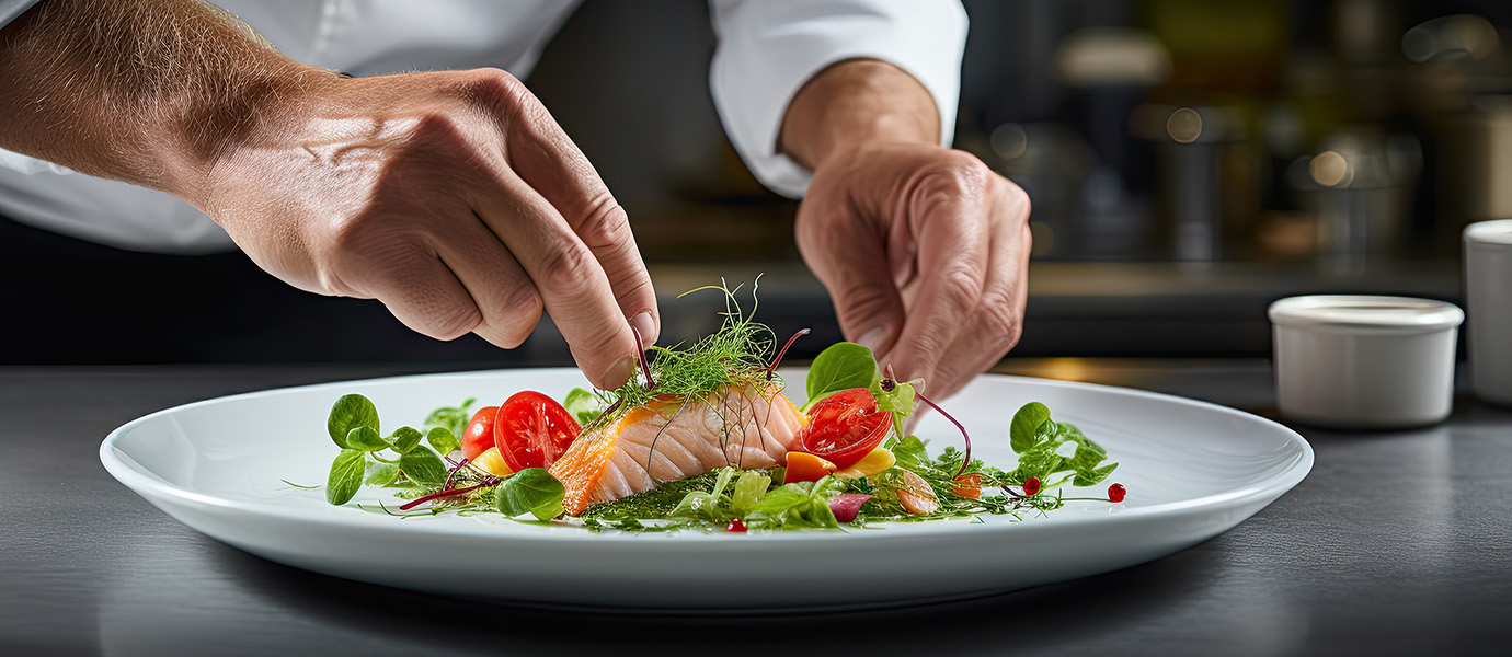 Chef's hands preparing a salmon dinner