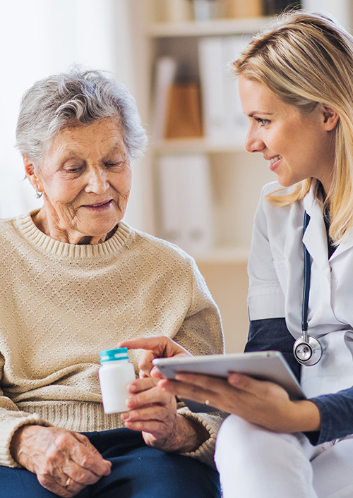 Doctor giving instructions to elderly woman