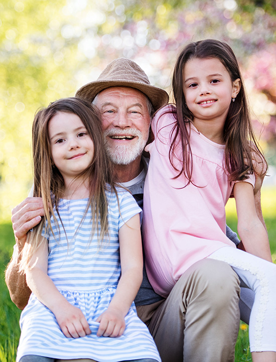 Grandpa smiles for a picture with grandkids